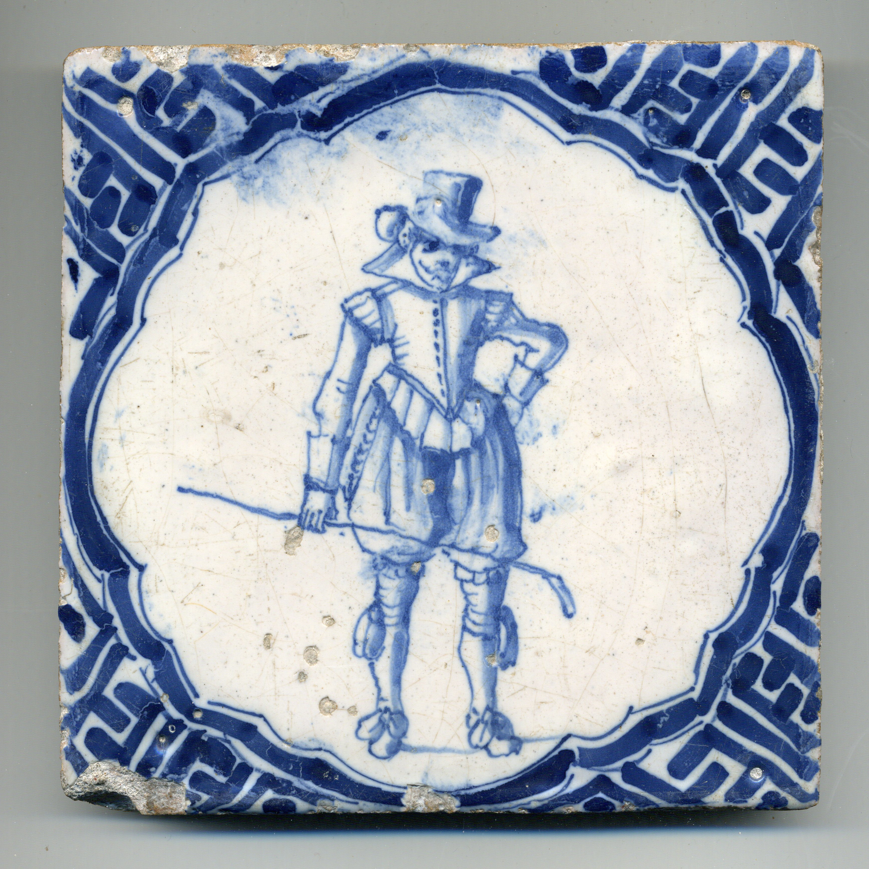 Wandtegel, wandelende heer met colfstok in de hand, Wan-Li rand. Ca. 1650