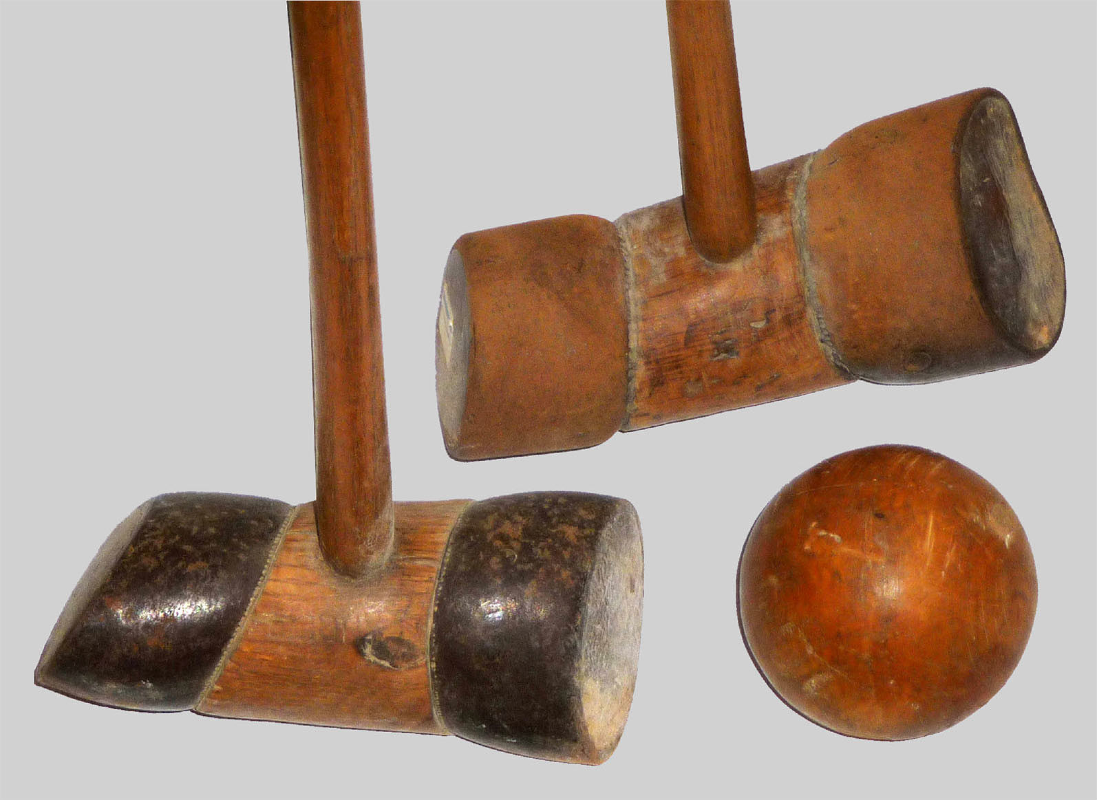 Two mail clubs with iron rings and a ball